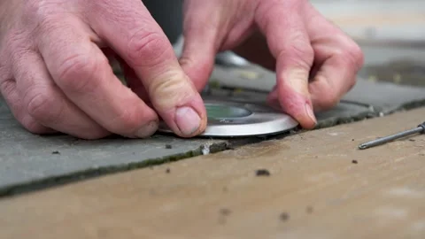Male hands assembling ground light on floor from replacing a failed bulb from Video stock 142273013