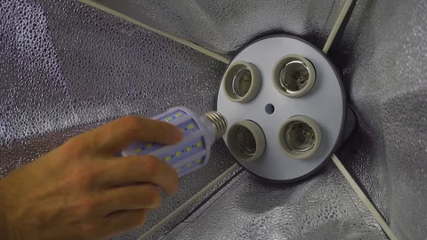 Male hands assembling a softbox, close up, photo shooting set, behind the scene Stock Footage 105470040