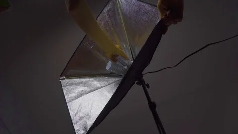 Male hands assembling a softbox, close up, photo shooting set, behind the scene Stock Footage 105470480