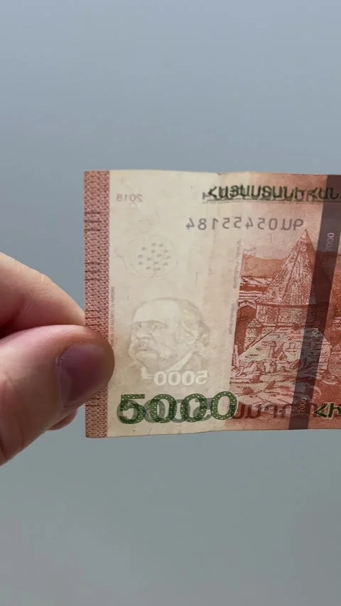 Male hands checking watermark on 5000 dram bill Stock Footage 332932469
