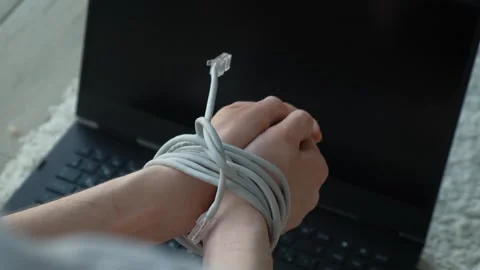 Male hands connected with an internet cable on a laptop background, close-up Stock Footage 273494121