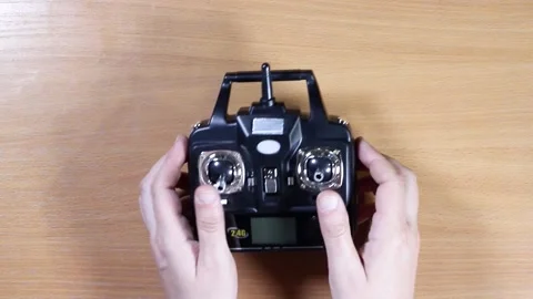 Male hands control the controller for the drone Stock Footage 133077363