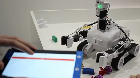 Male hands controls the robot with tablet Stock Footage 71891494