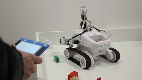 Male hands controls the robot with tablet Stock Footage 71891588