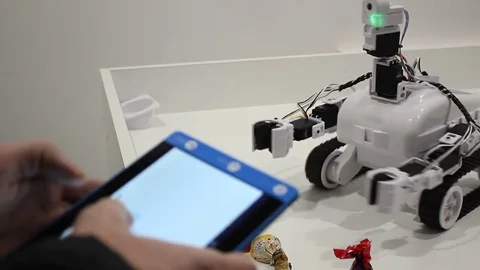 Male hands controls the robot with tablet Stock Footage 71891623