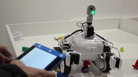Male hands controls the robot with tablet Stock Footage 71892157