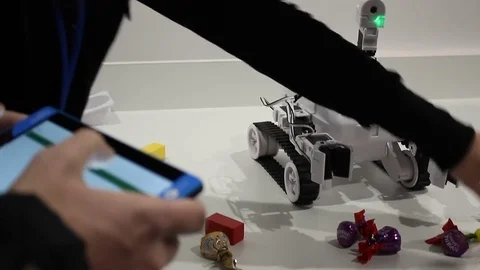 Male hands controls the robot with tablet Stock Footage 71892273