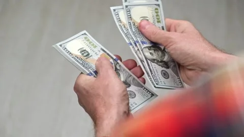 Male hands count a stack of cash hundred-dollar bills of the USA. close-up. Stock Footage 176373005