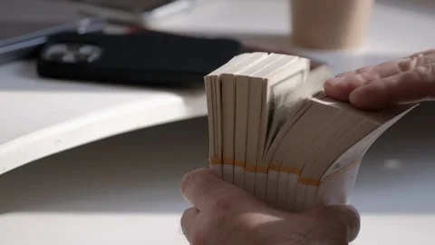 Male hands counting dollar banknotes sitting in room at table. Banking and Stock Footage 252932009