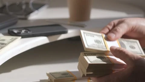 Male hands counting dollar banknotes sitting in room at table. Banking and Stock Footage 252932769