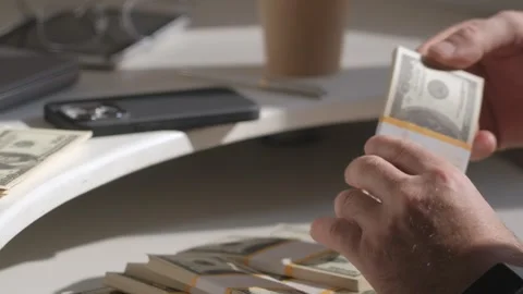 Male hands counting dollar banknotes sitting in room at table. Banking and Stock Footage 253618474