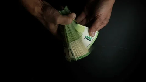 Male hands counting a large stack of euro bills, close-up on a dark background Stock Footage 265097429