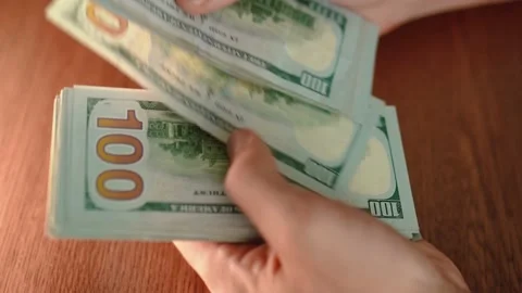 Male hands counting a stack of hundred-dollar US banknotes. Stock Footage 205037071