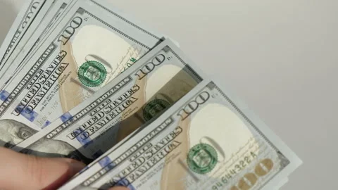 Male hands counting a stack of hundred-dollar US banknotes Stock Footage 231558107