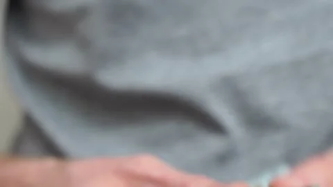 Male hands counting a stack of hundred-dollar US banknotes. Concept of Stock Footage 247046881