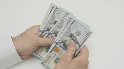Male hands counting stack of hundred-dollar Stock Footage 265878379