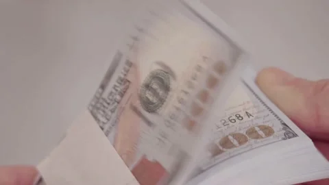Male hands counting a stack of new hundred-dollar US banknotes. a businessman is Stock Footage 194080564