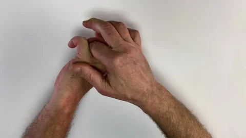 Male hands cracking knuckles and fingers together, isolated on white background. Stock Footage 333471025