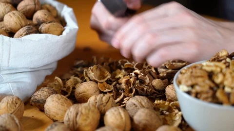 Male hands cracking walnuts with a nutcracker Stock Footage 121479851
