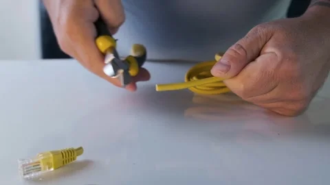 Male hands cutting ethernet cable with pliers, concept of internet shutdown Stock Footage 333728507