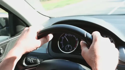 Male hands drive the car while holding the steering wheel. Stock Footage 157526260