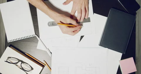 Male hands of engineer drawing project with pencil and ruler on paper Stock Footage 138527966