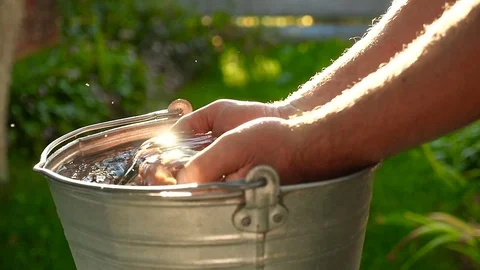 Male hands fall into the water. Sunlight. Close-up. Stock Footage 80313989