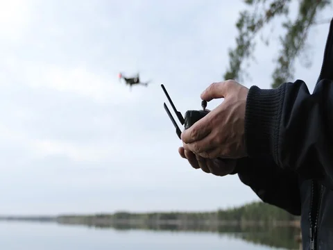 Male hands is getting experience in controlling drone outdoors. Stock Footage 75956280