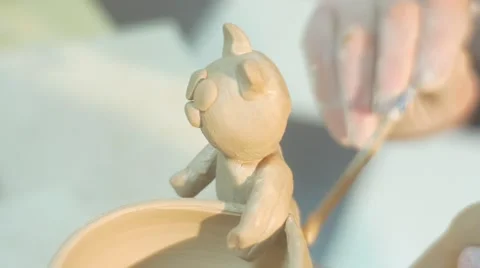 Male Hands Glue a Tail to a Clay Cat Statuette Fixed to a Pot Man is Putting a Video stock 59122073