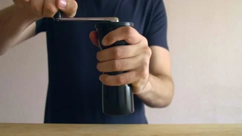 Male Hands Grinding coffee using manual hand grinder Stockbeeldmateriaal 132041827