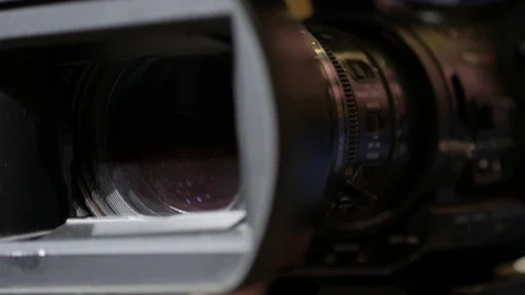 Male hands hold and move a large professional video camera in a close-up view. Video stock 119260053