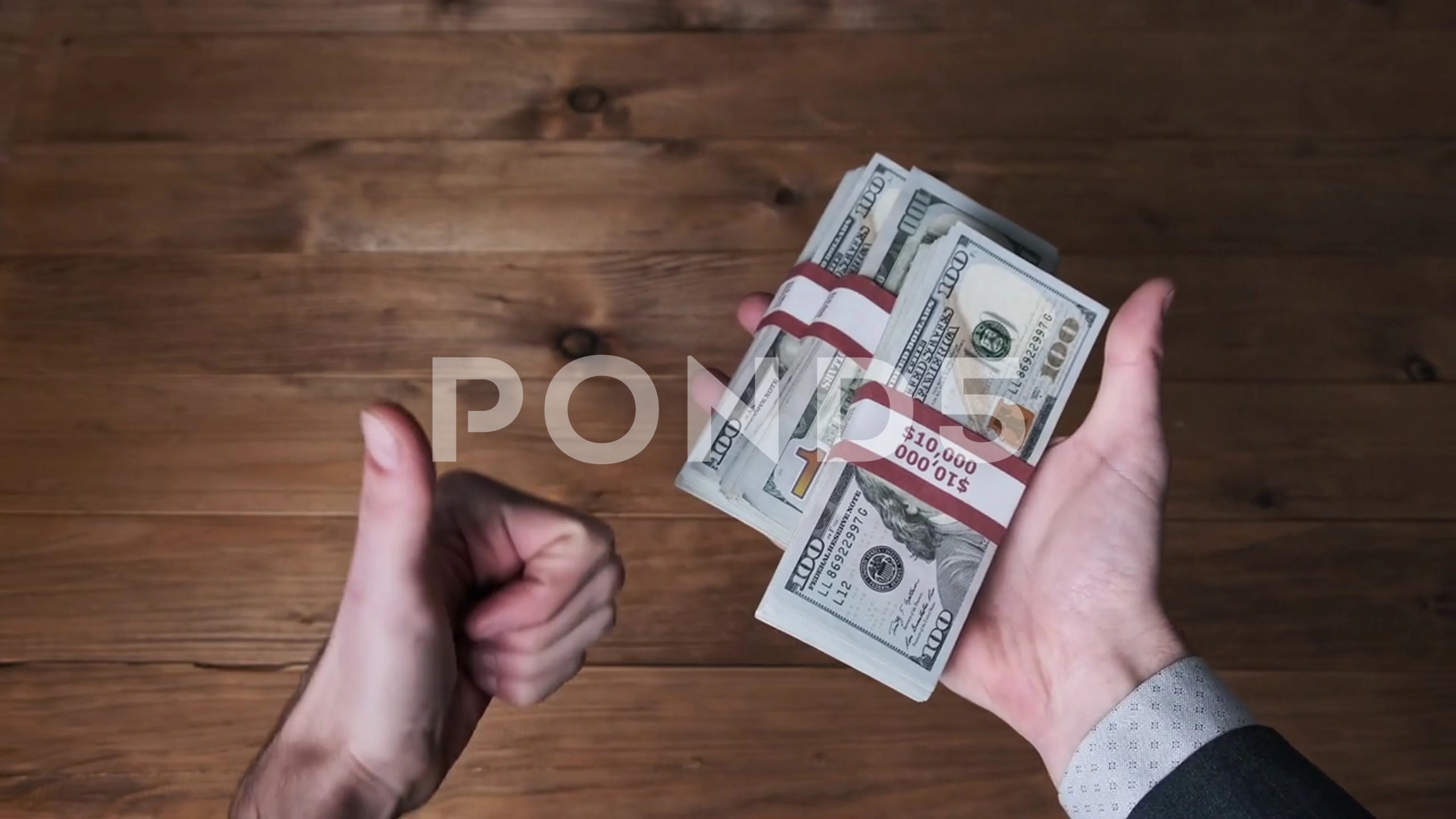 100 dollar bills stacks in hand