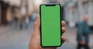 Male Hands Holding Black Smart Phone With Green Screen On City Street Background Stock Footage