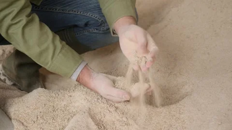 Male hands holding handful of corn germ meal on background of large pile Stock Footage 334100830