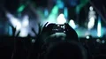 Male hands holding smartphone in air, filming amazing show on stage, slow-mo HD Footage
