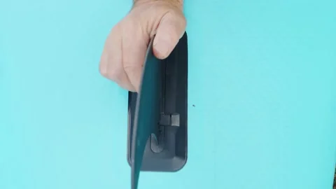 Male hands insert a fin from a SUP board preparing for a swim Stock Footage 205921362