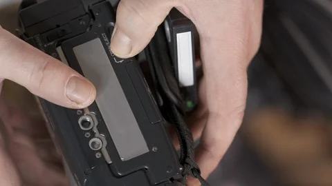 Male hands inserting mini DV cassette tape into the camcorder Stock Footage 99484711