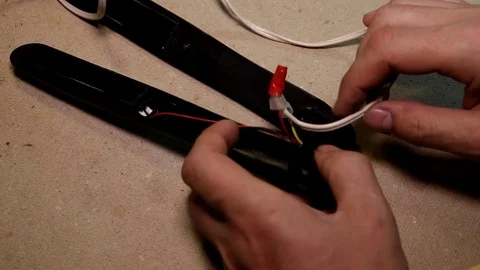 Male hands lay the wire in the process of repairing an electrical appliance Stock Footage 89435163