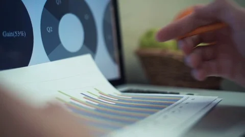 Male hands making note with pencil at printed analyzing graphs Stock Footage 82934808
