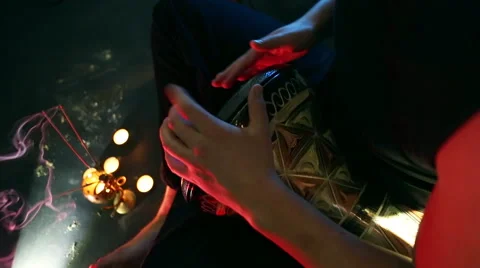 Male hands playing on darbuka, slow rhythm, incense and candles in the backgr Stockbeeldmateriaal 59643271
