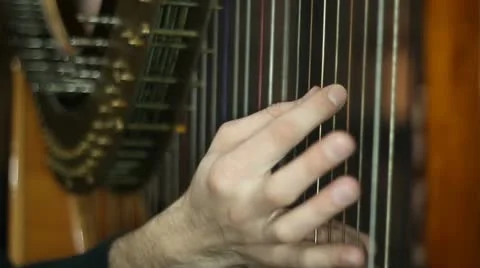 Male hands playing the harp Stock Footage
