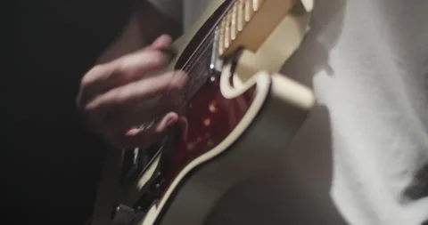 Male hands playing on strings with guitar plectrum Stock Footage 252212949