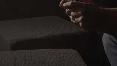 Male hands playing with videogame controller and throwing it away in Stock Footage 221756835