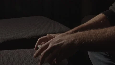 Male Hands playing with a videogame controller and putting it down and man Stock Footage 221756865