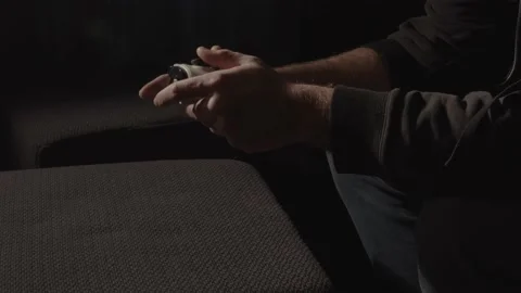 Male hands playing with videogame controller while light emitted from the Stock Footage 221756881