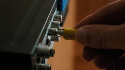 Male Hands Plug-In Rca Cables To Multimedia Electronic Device at Home. Close up Stock Footage 168029225