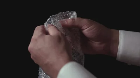 Male hands popping the bubbles in bubble wrap to relieve stress. Stock Footage