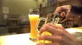 Male hands pouring bottled alcohol into glass at pub, beer brewing industry 4k or 4k+ Resolution