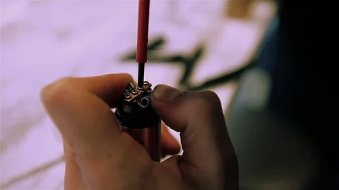 Male hands preload coils of the electronic cigarette. Stock Footage 73178245