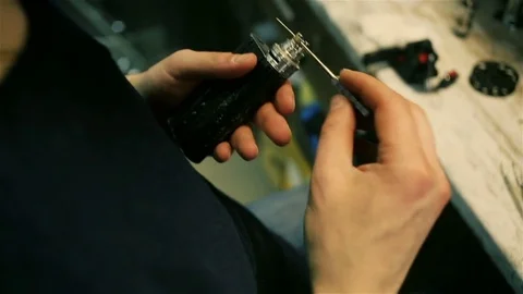 Male hands preload spirals for e-cigarette. Stock Footage 72933090